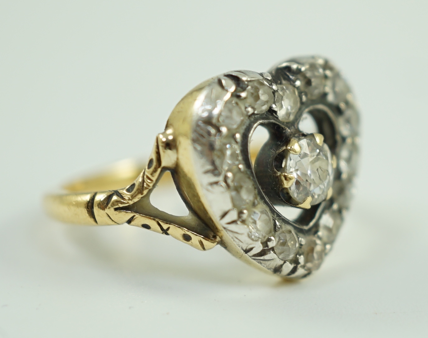 An antique gold and diamond set heart shaped open work cluster ring